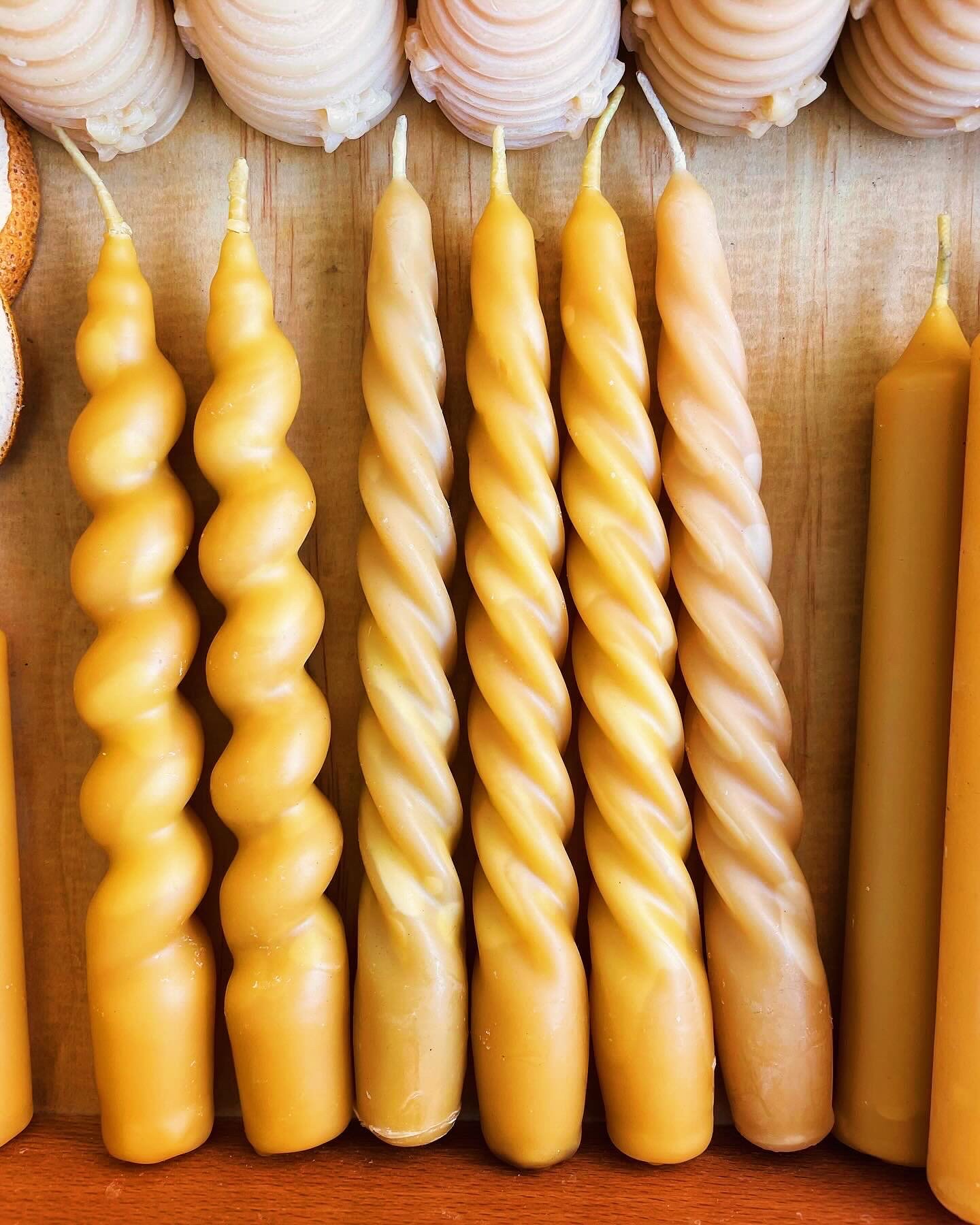Spiral beeswax taper candles standing in a row