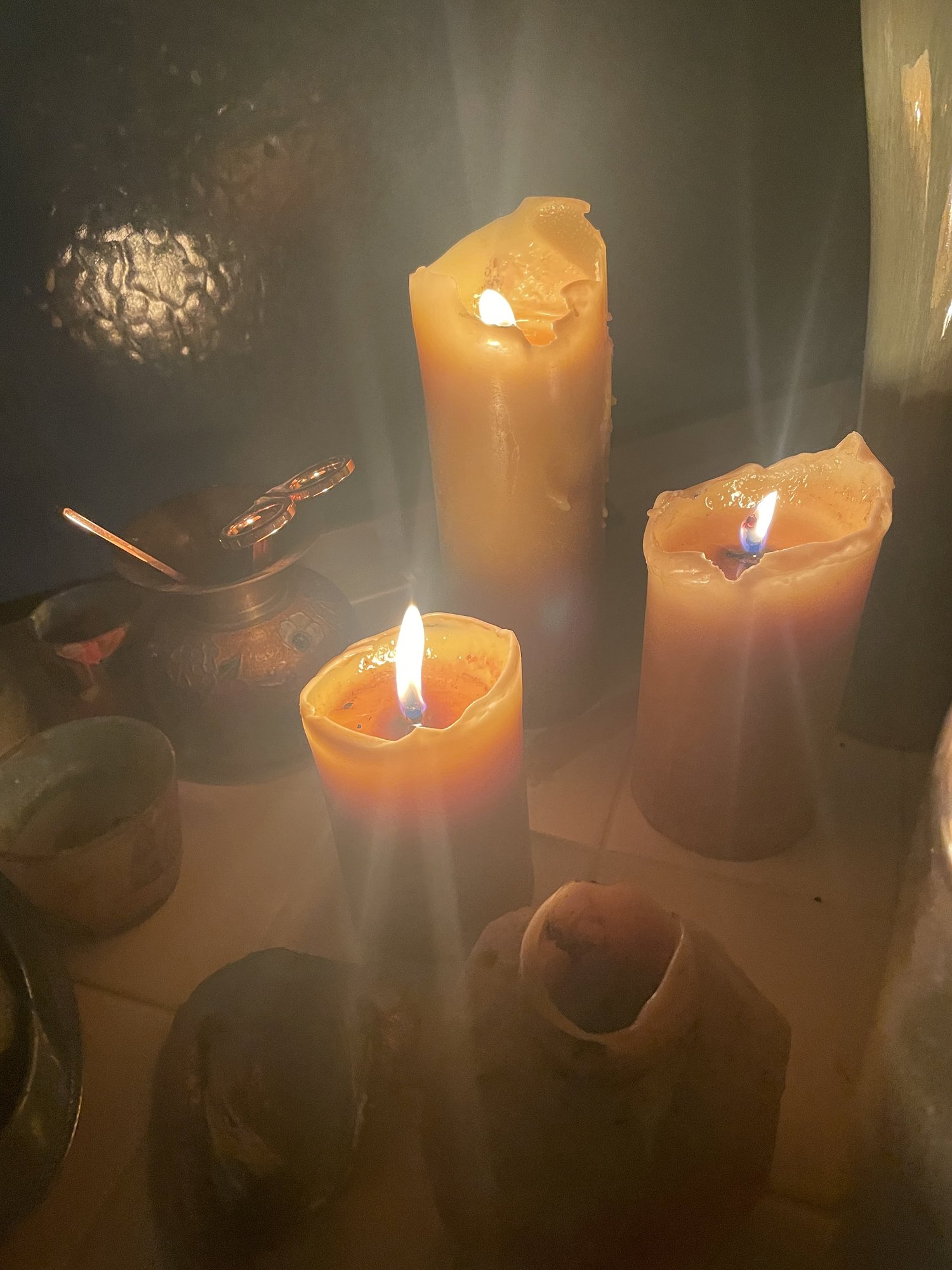 Beeswax candles burning with a warm golden light